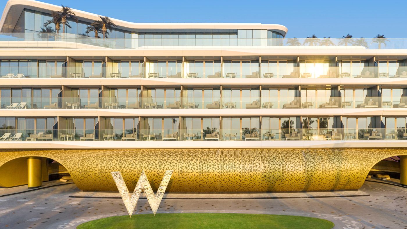 Exterior of W Dubai The Palm showing guest-room balconies and the waterfront hotel façade